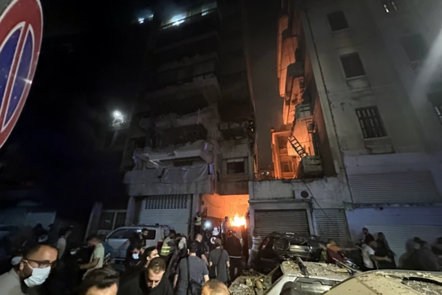 Crowds rush to rescue survivors from one of the apartment buildings hit in tonight's strike