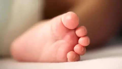 Getty Images Close-up image of a newborn baby's foot