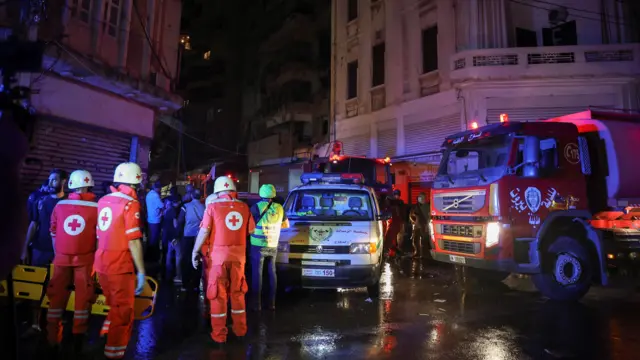 Members of the Red Cross work at the site of an Israeli air strike