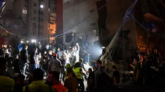 Members of the Red Cross work at the site of an Israeli air strike, amid ongoing hostilities between Hezbollah and Israeli forces, in Ras Al- Nabaa, in Beirut, Lebanon