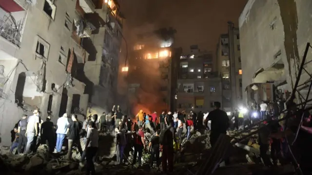 People conduct search and rescue works around the demolished apartment building aftermath of Israeli attack on the Nowayri neighborhood of Beirut, the capital of Lebanon on October 10, 2024