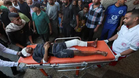 Reuters An injured Palestinian boy is brought to al-Aqsa hospital in Deir al-Balah after an Israeli air strike on a school sheltering displaced families in the central Gaza Strip (10 October 2024)