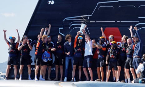 Ben Ainslie celebrates with Ineos crew members and the chairman, Jim Ratcliffe