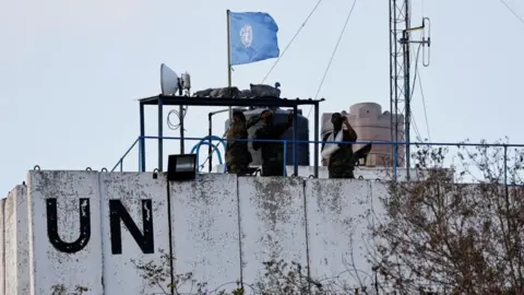 Reuters UN peacekeepers observe the border with Israel from an observation post in Marwahin, in southern Lebanon (12 October 2023)