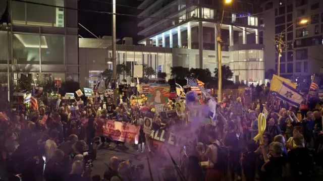 An overhead shot of protesters holding banners and flags