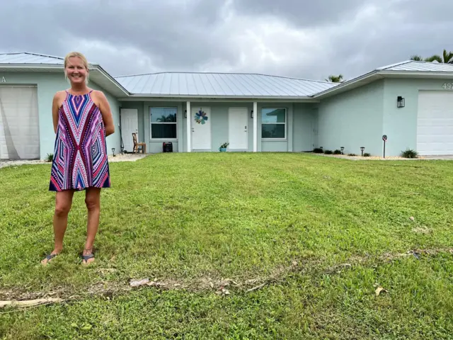 Cassandre Bennett standing outside her home