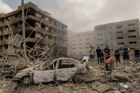 Joel Gunter/BBC An air strike on the edge of the Dahieh area that completely destroyed one building and damaged adjacent buildings, including a large gynaecology clinic