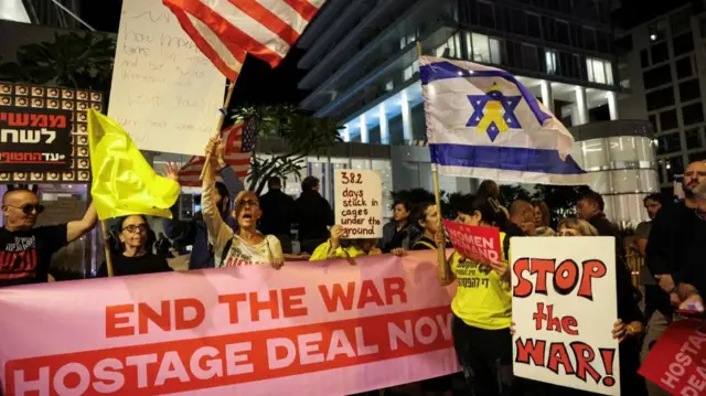 Protesters holding signs with captions including 'Stop the war!' and 'End the war, hostage deal now'