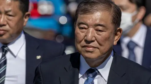 Getty Images Shigeru Ishiba, Japan's prime minister, leaves after delivering a campaign speech in Osaka. He is wearing a suit.