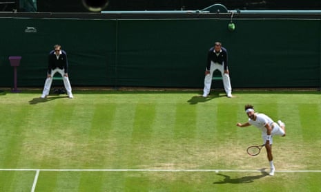 Line judges – assisted by Hawk-Eye since 2007 – keep watch for faults as Liam Broady serves at Wimbledon.