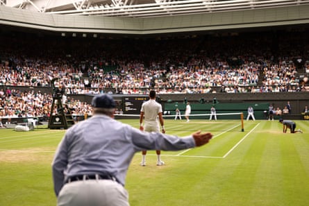 A line judge calls the ball out on Centre Court at Wimbledon.