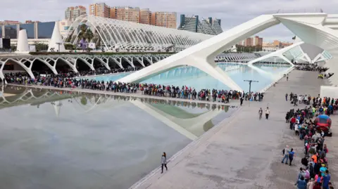 Reuters An aerial view shows queues of volunteers snaking around buildings and a body of water at the Ciudad de las Arts y las Ciencias in Valencia, Spain