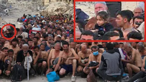 Supplied A group of dozens of detained Gazan men pictured in their underwear, during what appears to be an Israeli check for weapons and signs of any links to Hamas. They are sitting or squatting, some young and some older. At the far left of the picture, in the middle of the group, a little girl with dark hair can be seen. The BBC has chosen to blur the faces of the men nearer the front of the picture. In the background is a destroyed building, collapsed into rubble.