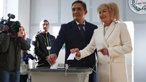 Reuters Moldova's presidential candidate Alexandr Stoianoglo and his wife Tvetana Kurdova cast ballots at a polling station during the second round of the presidential election in Chisinau, Moldova November 3, 2024