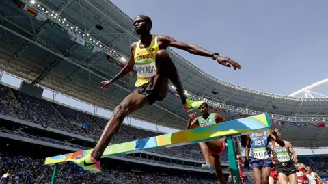 Getty Images Benjamin Kiplagat leaps over a hurdle during the steeplechase at the Rio Olympics.