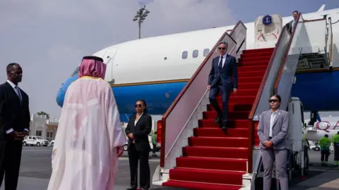 Getty Images The US secretary of state, Antony Blinken exits a plane and walks down stairs as he arrives in Doha on a recent visit to Qatar